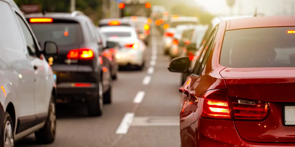 Cars lined up in heavy traffic on the highway during rush hour produce carbon monoxide.